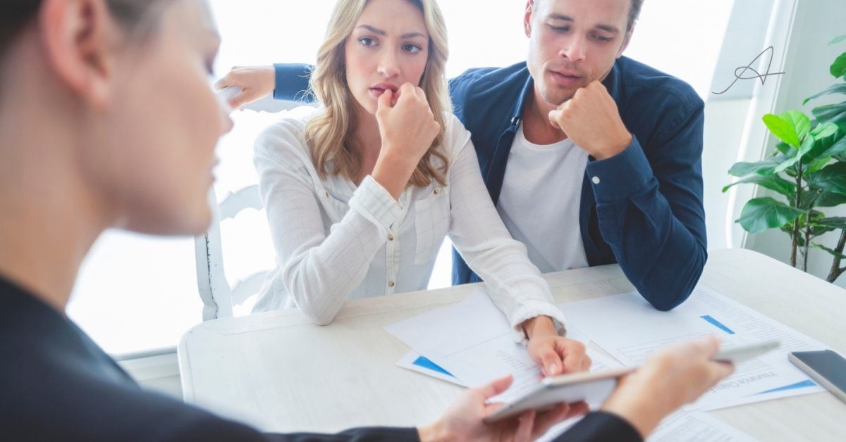 Woman and man talking to attorney.