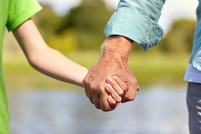 father and child holding hands