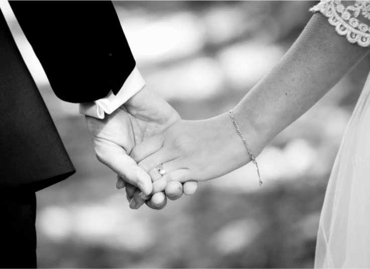 bride and groom holding hands