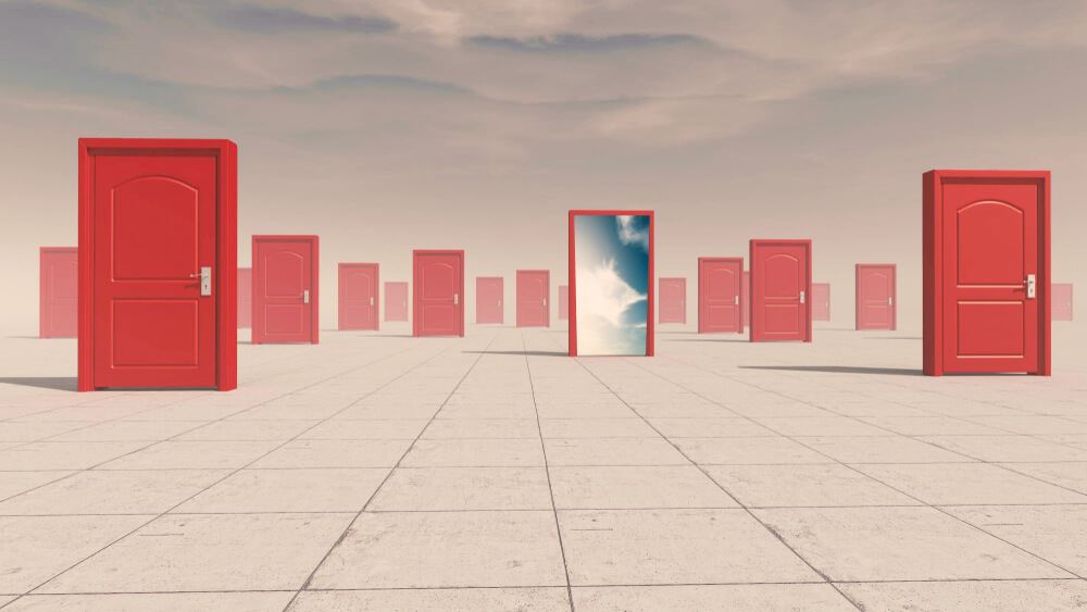 Group of closed doors and one opened to another world.