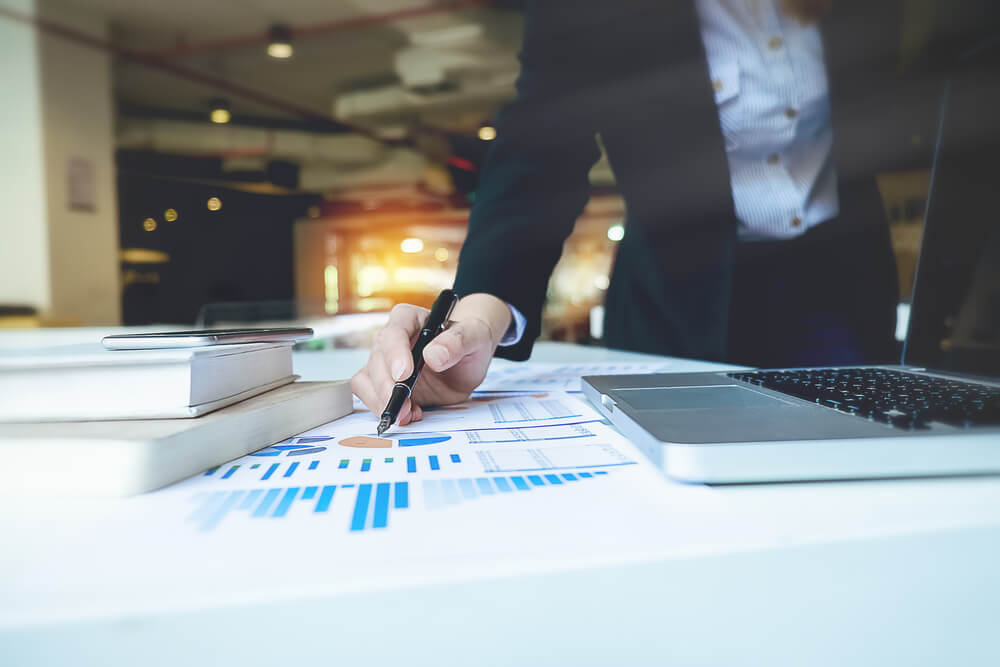 Business woman hand pointing business document during discussion at meeting